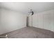 Clean bedroom with carpet flooring, a ceiling fan, and a closet with sliding doors at 2168 E Vista Bonita Dr, Phoenix, AZ 85024