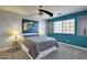 Bedroom with ceiling fan and blue accent wall at 2168 E Vista Bonita Dr, Phoenix, AZ 85024