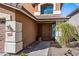 Warm and inviting entryway, with a brown front door and desert landscaping at 2168 E Vista Bonita Dr, Phoenix, AZ 85024