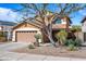 Two-story home with a two-car garage and desert landscaping with a tree in front at 2168 E Vista Bonita Dr, Phoenix, AZ 85024