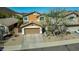 Two-story desert home with a two-car garage, desert landscaping, and solar panels on the roof at 2168 E Vista Bonita Dr, Phoenix, AZ 85024