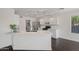 Modern kitchen with a large island, hardwood floors, and stainless steel appliances at 2168 E Vista Bonita Dr, Phoenix, AZ 85024