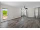 Spacious living room with wood-look tile floors, light-filled with access to balcony at 2168 E Vista Bonita Dr, Phoenix, AZ 85024