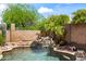 Sparkling pool featuring a rock waterfall and desert landscaping at 2168 E Vista Bonita Dr, Phoenix, AZ 85024