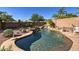 Backyard pool featuring a rock waterfall and desert landscaping at 2168 E Vista Bonita Dr, Phoenix, AZ 85024