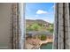 A view of the backyard pool and the mountain range can be seen from the open window at 2168 E Vista Bonita Dr, Phoenix, AZ 85024