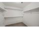 An empty walk-in closet with carpet flooring and white shelving ready for customization at 2168 E Vista Bonita Dr, Phoenix, AZ 85024