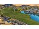 Breathtaking aerial view of homes in golf community with mountain views and a lake at 21915 N 65Th Ave, Glendale, AZ 85310