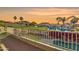 Scenic balcony view showcasing a lush golf course, serene pond, and vibrant bougainvillea in a tranquil setting at 21915 N 65Th Ave, Glendale, AZ 85310