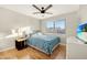 Bright bedroom features a ceiling fan, wood floors, and a window with natural light at 21915 N 65Th Ave, Glendale, AZ 85310