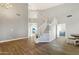 Bright entryway features wood floors, staircase and view to a living area with beach scene at 21915 N 65Th Ave, Glendale, AZ 85310