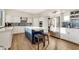 Bright kitchen featuring white cabinets, navy blue island, stainless steel appliances, and modern tile backsplash at 21915 N 65Th Ave, Glendale, AZ 85310