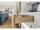 Kitchen drawer close up featuring modern white cabinetry, stainless steel hardware, and wood-look flooring at 21915 N 65Th Ave, Glendale, AZ 85310