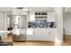 Stylish kitchen featuring stainless steel refrigerator, crisp white cabinetry, blue tile backsplash, and modern decor at 21915 N 65Th Ave, Glendale, AZ 85310