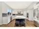 Bright, modern kitchen boasts a large center island, stainless appliances, white cabinets, and stylish blue tile backsplash at 21915 N 65Th Ave, Glendale, AZ 85310