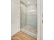 Shower with glass doors and a stylish mosaic tile floor at 21915 N 65Th Ave, Glendale, AZ 85310