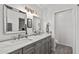 Elegant bathroom with a double vanity, stylish mirrors, and modern lighting at 24021 N 39Th Ln, Glendale, AZ 85310