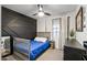 Charming bedroom with a striking accent wall and a modern ceiling fan at 24021 N 39Th Ln, Glendale, AZ 85310