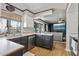 Well-lit kitchen featuring modern appliances, dark cabinets, and hardwood floors at 24021 N 39Th Ln, Glendale, AZ 85310