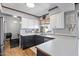 Well-lit kitchen featuring stainless steel appliances, wood floors and two-tone cabinets at 24021 N 39Th Ln, Glendale, AZ 85310