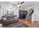 Spacious living room featuring hardwood floors, neutral walls, and access to the staircase at 24021 N 39Th Ln, Glendale, AZ 85310