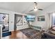 Open-concept living room with hardwood floors, large windows, and a mounted television at 24021 N 39Th Ln, Glendale, AZ 85310