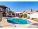 A refreshing pool with a travertine tile deck and a covered patio providing an inviting space for outdoor living at 24021 N 39Th Ln, Glendale, AZ 85310