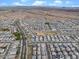 Sprawling aerial shot of a vast neighborhood with mountain views, roads and desert landscaping at 25268 N 142Nd Dr, Surprise, AZ 85387