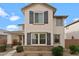 Two-story home features stone accents, gray shutters, and neutral stucco at 25268 N 142Nd Dr, Surprise, AZ 85387