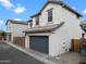 Exterior view of a two-story home with a grey garage door, stucco finish, and tiled roof at 25268 N 142Nd Dr, Surprise, AZ 85387