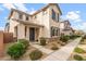 Charming two-story home features desert landscaping, gray shutters, and covered front porch at 25268 N 142Nd Dr, Surprise, AZ 85387