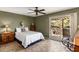 Bedroom with olive-colored walls, ceiling fan, and access to the outside seating area at 25621 N Cordova Ln, Rio Verde, AZ 85263