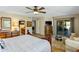 Bright main bedroom features ornate wood furnishings, sitting area and outdoor access through a glass sliding door at 25621 N Cordova Ln, Rio Verde, AZ 85263