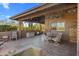 Cozy outdoor patio with tile flooring, built-in bench, table set and serene desert views at 25621 N Cordova Ln, Rio Verde, AZ 85263