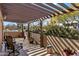 Outdoor patio area with a pergola and mature landscaping, providing ample shade and privacy at 25621 N Cordova Ln, Rio Verde, AZ 85263