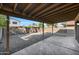 Covered patio and spacious gravel backyard with a block fence at 2706 W Estrella Dr, Chandler, AZ 85224