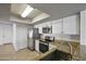 Well-lit kitchen with granite countertops, stainless steel appliances, and white cabinetry at 2706 W Estrella Dr, Chandler, AZ 85224