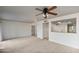 Spacious living room with plush carpeting and a cutout to the kitchen at 2706 W Estrella Dr, Chandler, AZ 85224