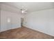 Bright main bedroom with ceiling fan, neutral walls, and adjoining bathroom access at 2706 W Estrella Dr, Chandler, AZ 85224