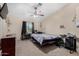 Bedroom with a ceiling fan, carpeted floors, and a window offering natural light at 2848 E Brown Rd # 30, Mesa, AZ 85213