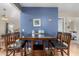 Cozy dining area adjacent to living room with seating for four, and a blue accent wall at 2848 E Brown Rd # 30, Mesa, AZ 85213