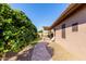 Paver pathway, pergola, and lush greenery, creating a serene backyard oasis with mature shrubs at 2854 S Berrywood --, Mesa, AZ 85212