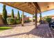 Covered patio with pavers, BBQ area, landscaping, and views of the beautifully designed backyard at 2854 S Berrywood --, Mesa, AZ 85212