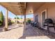 Inviting covered patio with brick pavers, seating, grill, and a view of a well-maintained backyard at 2854 S Berrywood --, Mesa, AZ 85212