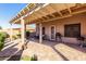 Back patio featuring a covered pergola with seating and a grill, overlooking lush backyard landscaping at 2854 S Berrywood --, Mesa, AZ 85212