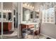 Bright bathroom featuring updated fixtures, wooden vanity, and mirrors that enhance the space's openness at 2854 S Berrywood --, Mesa, AZ 85212