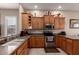 Well-lit kitchen featuring stainless steel appliances, wood cabinets, and ample counter space at 2854 S Berrywood --, Mesa, AZ 85212