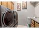 Modern laundry room featuring front load washer and dryer, with utility sink and storage cabinets at 2854 S Berrywood --, Mesa, AZ 85212