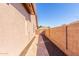 Paver-lined side yard pathway with gravel, leading to a private gate, and decorative brick features at 2854 S Berrywood --, Mesa, AZ 85212