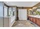 Bright bathroom with a soaking tub next to a privacy window and double vanity with stylish tile floor at 29740 W Fairmount Ave, Buckeye, AZ 85396